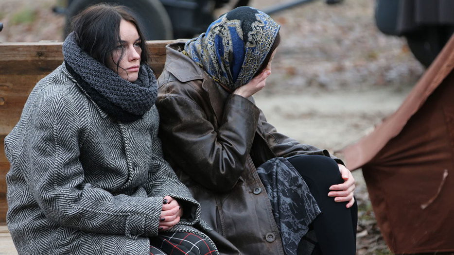 Two tired women sitting outside in Ukraine.