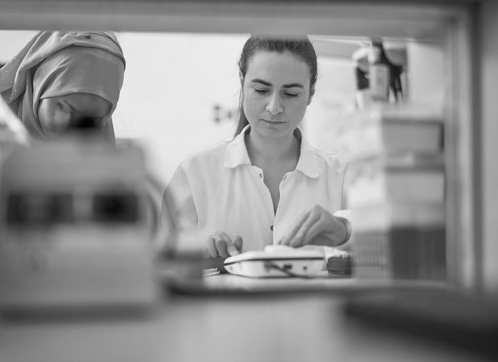 Two women in white lab coats  working in laboratory.