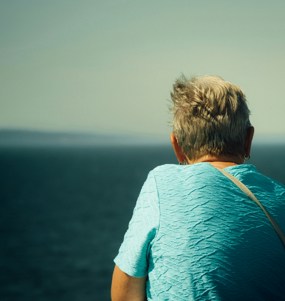 Older woman watching the horizon.